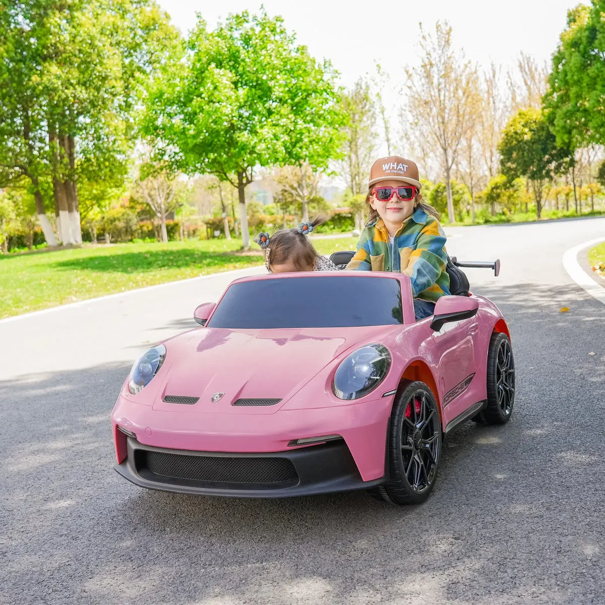 Kids in a licensed pink Porsche 911 ride-on
